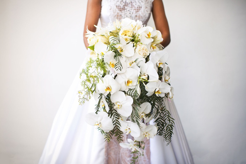 Cascading Bouquet of Orchids %26 Greenery
Photography: Callaway Gable
Read More:
http://www.insideweddings.com/weddings/modern-in-the-round-ceremony-whimsical-garden-inspired-reception/1155/ Bride in wedding dress a line holding large cascade bouquet with orchid flowers fresh greenery