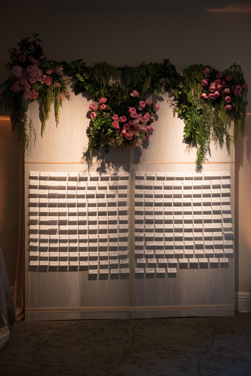 Wall of Escort Cards %26 Blooms
Photography: Jay Lawrence Goldman Photography
Read More:
http://www.insideweddings.com/weddings/outdoor-ceremony-ballroom-reception-with-pink-flowers-greenery/1135/ Wedding reception cocktail hour escort card display wall pink roses greenery on top