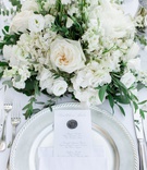 Silver Elements in Place Setting
Photography: Thanos Asfis Photography
Read More:
http://www.insideweddings.com/weddings/four-day-destination-wedding-celebration-on-island-in-greece/1299/ silver charger plate, silver wax seal on menu, white napkin and menu, ivory roses