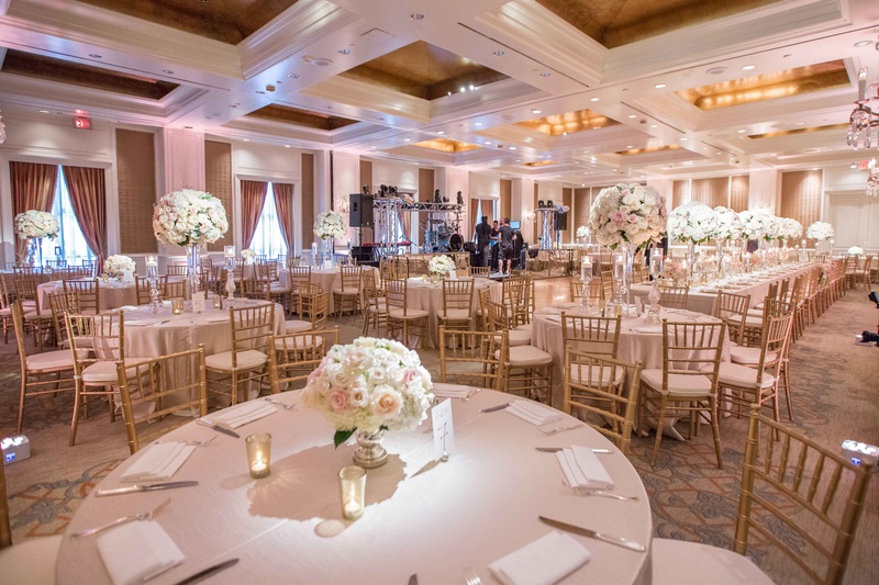 Reception Space in Pink and White
Photography: Perez Photography
Read More:
http://www.insideweddings.com/weddings/persian-american-ceremony-with-light-hued-reception-in-dallas/841/ large indoor reception space round and long tables white pink tall small floral dance floor
