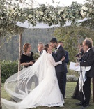 Natural Chuppah in Tuscany
Photography: The Day by Ira Lippke
Read More:
http://www.insideweddings.com/weddings/romantic-ceremony-on-bluff-tented-reception-in-tuscany/1311/ bride and groom kiss under chuppah with natural posts, ivory flowers, and greenery