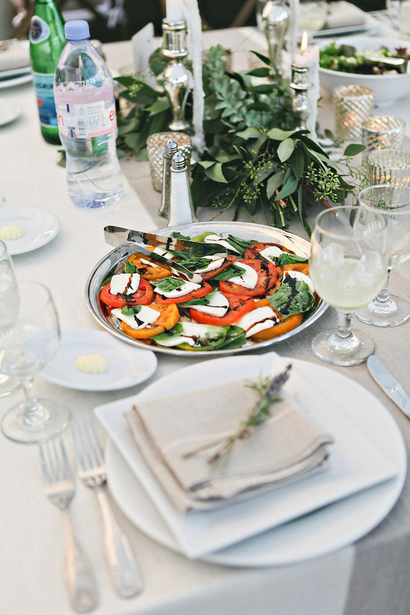 Caprese Salad on Silver Plate
Photography: Stacy Newgent
Read More:
http://www.insideweddings.com/weddings/rustic-barn-wedding-tented-reception-on-family-farm-in-ohio/690/ Farm wedding reception table with a silver platter of caprese salad, greenery garlands