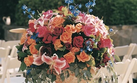 Vibrant Flower Arrangement
Photography: Shannon’s Photography
Read More:
http://www.insideweddings.com/weddings/summer-wedding-with-garden-inspired-decor-in-california/50/ Pink lilies red and orange roses aisleway