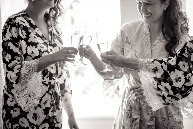Bride %26 Bridesmaids Sipping Champagne
Photography: Magnolia Studio
Read More:
http://www.insideweddings.com/weddings/charming-church-ceremony-romantic-ballroom-reception-in-quebec/1075/ Black and white photo of bride in robe cheers sipping champagne in flutes with bridesmaids in robe