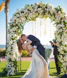 Newlywed Couple's Dip Kiss
Photography: Michael Svoboda Wedding Photography
Read More:
http://www.insideweddings.com/weddings/boho-chic-wedding-with-ocean-elements-in-southern-california/933/ newlywed couple dip kiss outdoor ceremony flowers garden wedding beach floral arch slit dress ca