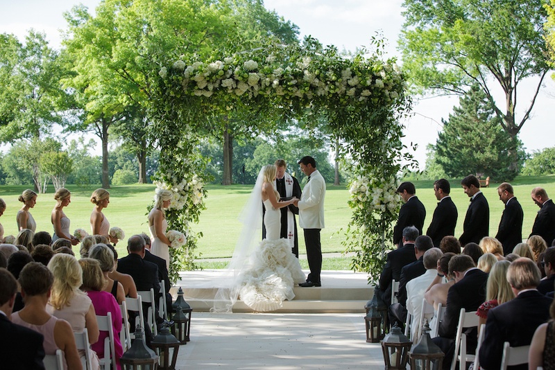 Outdoor Altar with Leafy %26 Floral Structure
Photography: Karlisch Studio
Read More:
http://www.insideweddings.com/weddings/southern-chic-wedding-in-oklahoma-with-performance-by-boyz-ii-men/697/ Bride in a fit-and-flare Vera Wang dress, ruffled skirt, veil & groom in white tux jacket at outdoor
