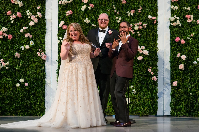 Excited Couple at Ceremony
Photography: Kent Drake Photography
Read More:
http://www.insideweddings.com/weddings/an-event-planners-wedding-at-a-museum-by-sue-the-tyrannosaurus-rex/955/ Bride and groom flash wedding rings at wedding ceremony hedge wall flower wall ceremony ideas