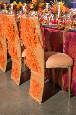 an inspirational reception tablescape with a fiery color scheme