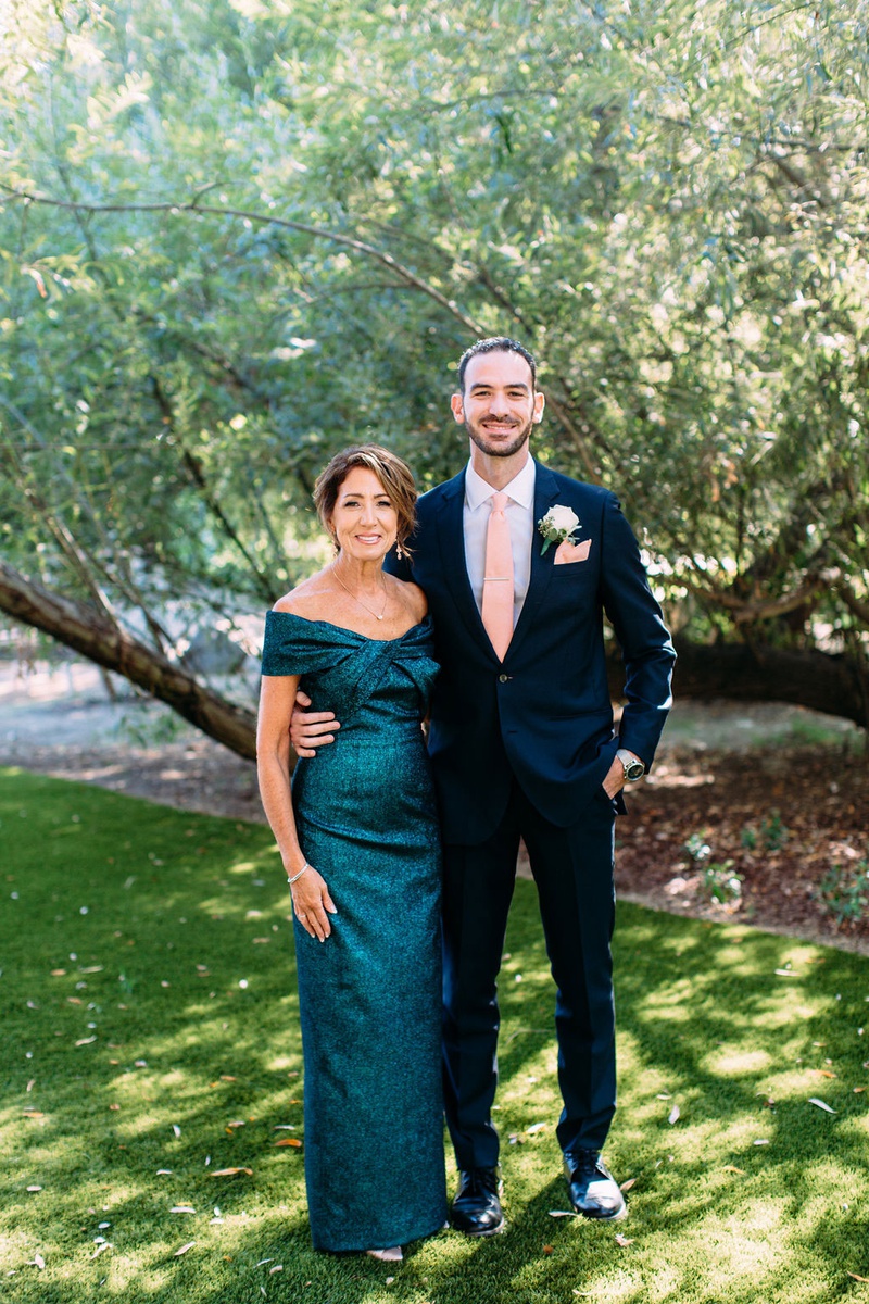 Mother of Groom in Teal Gown
Photography: Ashley Paige Photography
Read More:
http://www.insideweddings.com/weddings/elegant-outdoor-fall-wedding-at-a-rustic-chic-venue-in-malibu/1244/ groom in suit with pink tie and mother of groom in off shoulder teal blue green gown