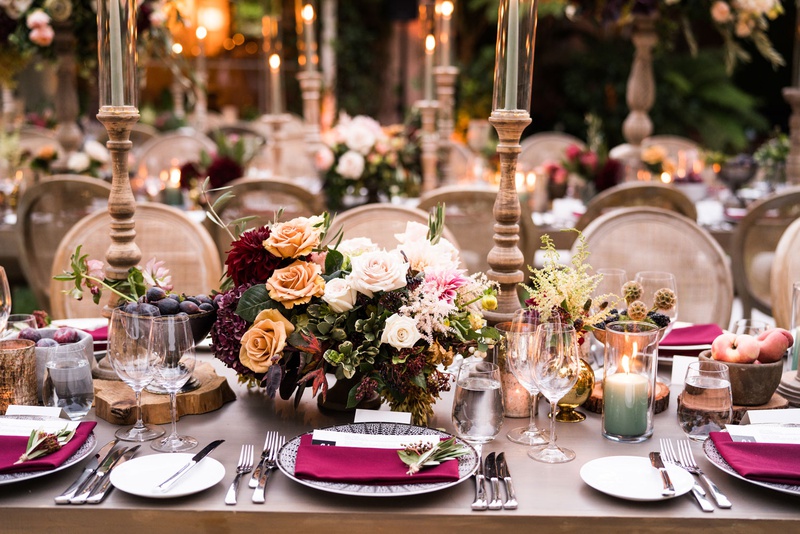 Fall-Inspired Outdoor Tablescape
Photography: Samuel Lippke Studios
Read More:
http://www.insideweddings.com/weddings/tuscany-meets-rustic-california-outdoor-wedding-under-the-stars/1336/ wedding reception table wood with burgundy flowers napkins candles taper candles outdoor wedding