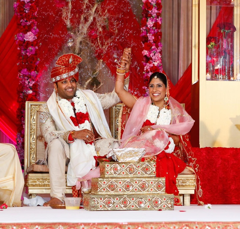 Bride and Groom at Indian Ceremony
Photography: Tomas Ramos Photographers
Read More:
http://www.insideweddings.com/weddings/houston-indian-wedding-celebration-with-800-person-guest-list/435/ Indian bride in red lehenga and Indian groom in white sherwani at wedding ceremony