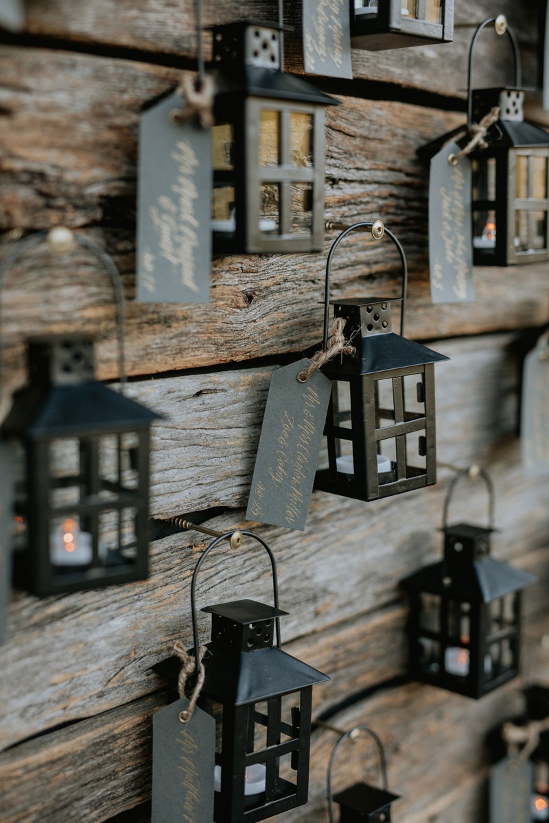 Black Lanterns with Seating Assignments
Photography: Grant Daniels Photography
Read More:
http://www.insideweddings.com/weddings/outdoor-ceremony-tented-reception-with-cozy-fall-color-palette/1183/ wedding reception escort card display reclaimed wood wall black lantern with tag place card