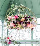 Spherical Chandelier with Flowers
Photography: Rebecca Cerasani
Read More:
http://www.insideweddings.com/weddings/fairy-tale-romance-inspiration-with-abundance-of-bright-florals/1356/ floral chandelier shaped like a sphere with cascading crystal accents