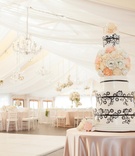 Tent Wedding Cake Table
Photography: Carrie Rodman Photography
Read More:
http://www.insideweddings.com/weddings/new-england-summer-wedding-by-the-seashore/429/ Pink tablecloth over round table with black-and-white cake