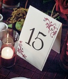 Rhinestone-Studded Table Card
Photography: John Solano Photography
Read More:
http://www.insideweddings.com/weddings/summertime-wedding-with-deep-red-hues-in-ojai-valley-california/240/ White pyramid cards with motif and jewels