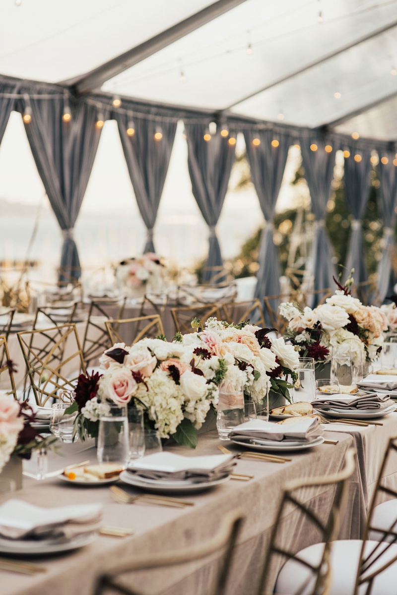 Low Centerpieces at Clear Tent Reception
Photography: Sam %26 Sola Lee Photography
Read More:
http://www.insideweddings.com/weddings/modern-outdoor-ceremony-tent-reception-in-seattle-on-puget-sound/1309/ wedding reception neutral linens low centerpiece white blush burgundy grey drapes string lights