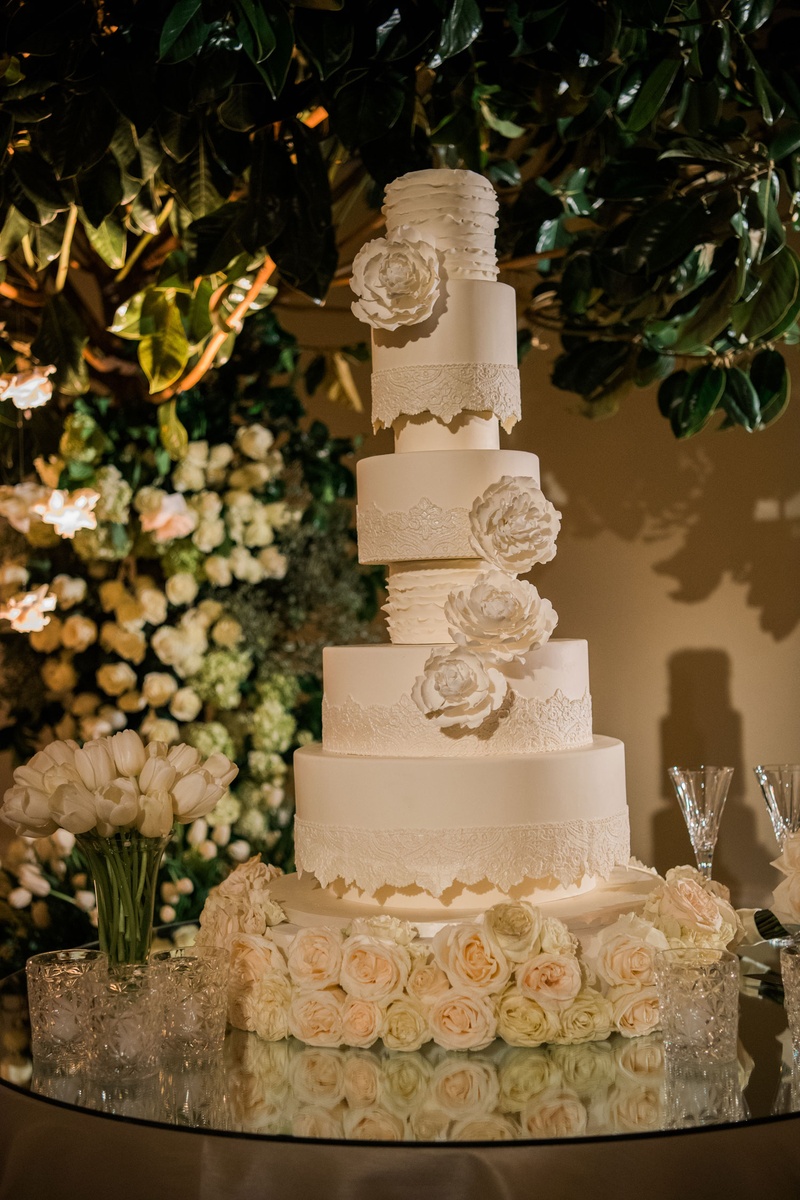 Towering Ivory Cake with Sugar Peonies
Photography: John Solano Photography
Read More:
http://www.insideweddings.com/weddings/an-opulent-garden-ceremony-ballroom-reception-in-beverly-hills/986/ Tall white wedding cake with sugar flower peony design and invitation escort card design style