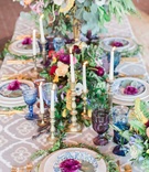 Vibrant Centerpieces with Metallic Candlesticks
Photography: Lucas Rossi
Read More:
http://www.insideweddings.com/weddings/vibrant-styled-shoot-with-colorful-bohemian-inspired-details/793/ colorful centerpieces with gold and silver candlesticks maroon flowers greenery colored glassware