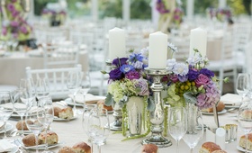 Garden-Chic Centerpiece
Photography: Sarah Tew Photography
Read More:
http://www.insideweddings.com/weddings/garden-chic-summer-wedding-in-brooklyn/510/ Mercury glass candlesticks next to purple flower centerpiece