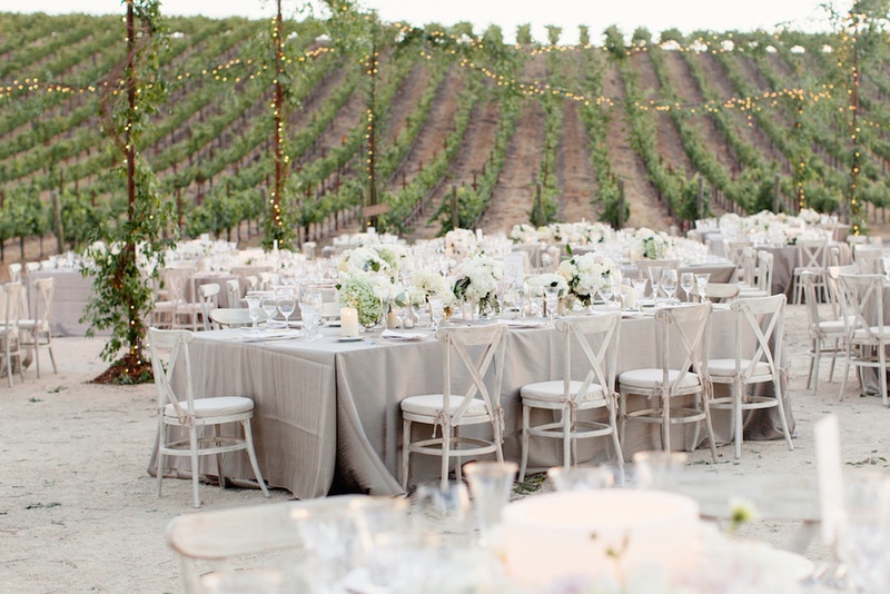Vineyard Wedding Reception
Photography: Elisabeth Millay Photography
Read More:
http://www.insideweddings.com/weddings/romantic-neutral-hued-wedding-at-a-paso-robles-california-vineyard/585/ Outdoor vineyard wedding with grey linens and white flowers