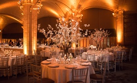 Bright Uplighting and White Tablescapes
Photography: Ira Lippke Studios
Read More:
http://www.insideweddings.com/weddings/chic-classic-new-york-city-wedding-with-personal-touches/783/ a reception space with circular tables featuring white table linens and bright uplighting