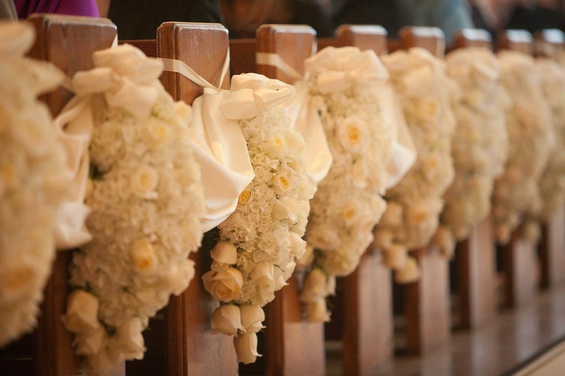 Floral Decor
Photography: Josh Lynn Photography
Read More:
http://www.insideweddings.com/weddings/purple-white-gold-new-jersey-celebration/339/ Pews decorated with arrangements of white flowers for a wedding