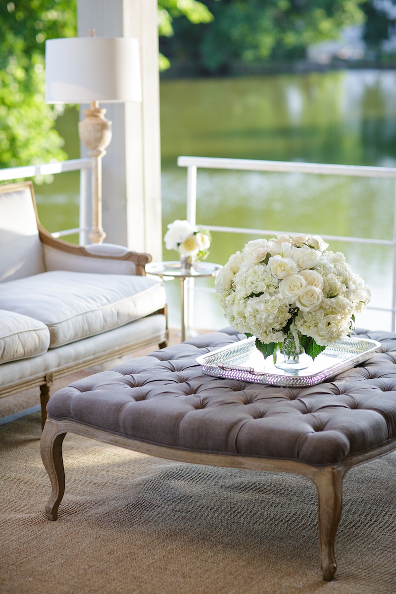 Elegant Reception Lounge Area
Photography: Karlisch Studio
Read More:
http://www.insideweddings.com/weddings/southern-chic-wedding-in-oklahoma-with-performance-by-boyz-ii-men/697/ Reception lounge area with a grey tufted top wood table, vase with white roses, hydrangeas, peonies