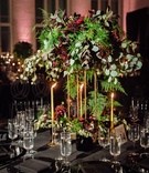 Tall, Loose Greenery Centerpiece
Photography: Erika Delgado Photography
Read More:
http://www.insideweddings.com/weddings/unique-wedding-with-greenery-black-and-oxblood-decor-in-miami/1091/ Tall centerpiece of unstructured greenery and oxblood flowers tall taper candles in gold black linen