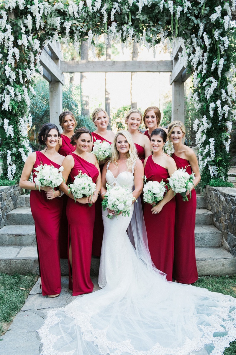 Bride with Bridesmaids in Scarlet
Photography: This Modern Romance
Read More:
http://www.insideweddings.com/weddings/rustic-chic-wedding-with-wooden-accents-and-verdant-details/861/ bride in galia lahav, bridesmaids in scarlet one-shoulder dresses with a high slit