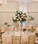 Tall Centerpieces and Blue Glasses
Photography: Jillian Rose Photography
Read More:
http://www.insideweddings.com/weddings/indoor-wedding-with-beach-inspired-color-palette-in-santa-monica/1052/ wedding centerpiece with white roses and greenery, pale blue glasses, gold chiavari chairs