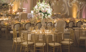 Champagne %26 Ivory Bouquet in Crystal Vase
Photography: Chip Gillespie
Read More:
http://www.insideweddings.com/weddings/classic-jewish-wedding-at-a-synagogue-in-houston-texas/718/ Wedding reception table with gold sequined linen, cut crystal vase with white hydrangeas, orchids