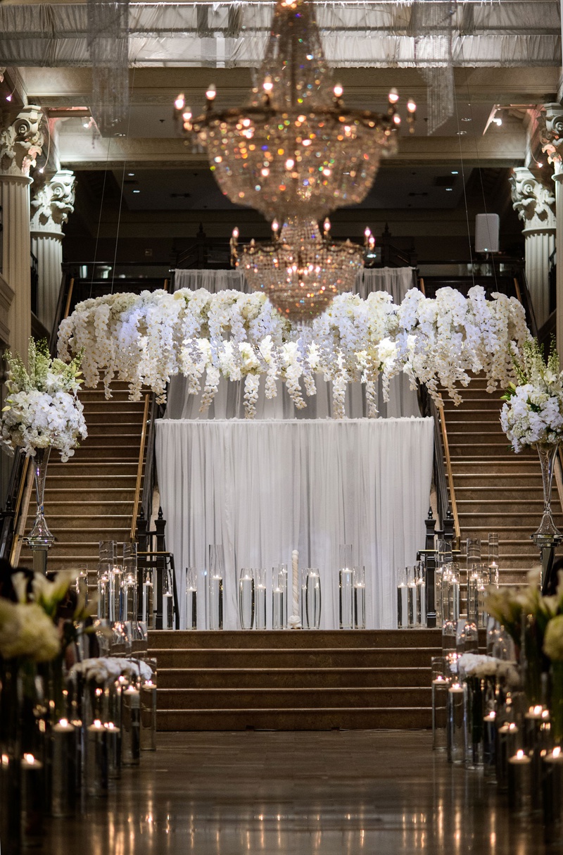 Stage with Drapery and Floating Candles
Photography: Chris Bailey Photography
Read More:
http://www.insideweddings.com/weddings/modern-elegant-ballroom-wedding-with-white-flowers-in-houston/1246/ wedding ceremony stage floating candles white drapery orchid flowers in halo wreath over vow spot