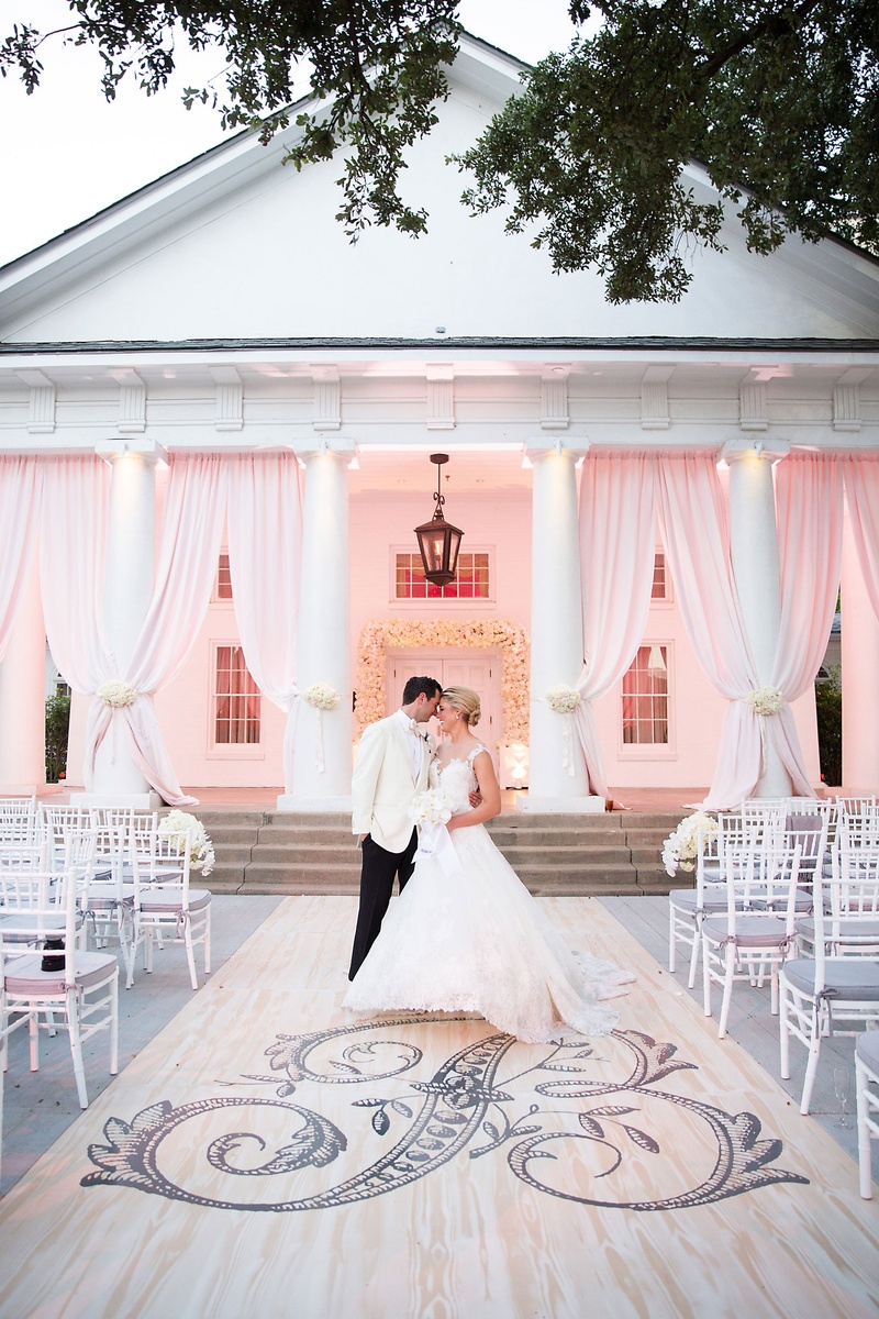 Bride %26 Groom on Wood Aisle Runner
Photography: Sarah Kate, Photographer
Read More:
http://www.insideweddings.com/weddings/outdoor-fall-ceremony-opulent-tented-reception-in-dallas-texas/1022/ Wedding portrait in front of ceremony decor large monogram on aisle runner pink drapes white chairs