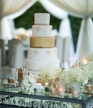 White-and-Gold Wedding Cake on Table
Photography: Samuel Lippke Studios
Read More:
http://www.insideweddings.com/weddings/alfresco-ceremony-with-ocean-view-glamorous-tented-reception/1081/ White and gold wedding cake on crystal table white flower bouquets champagne flutes