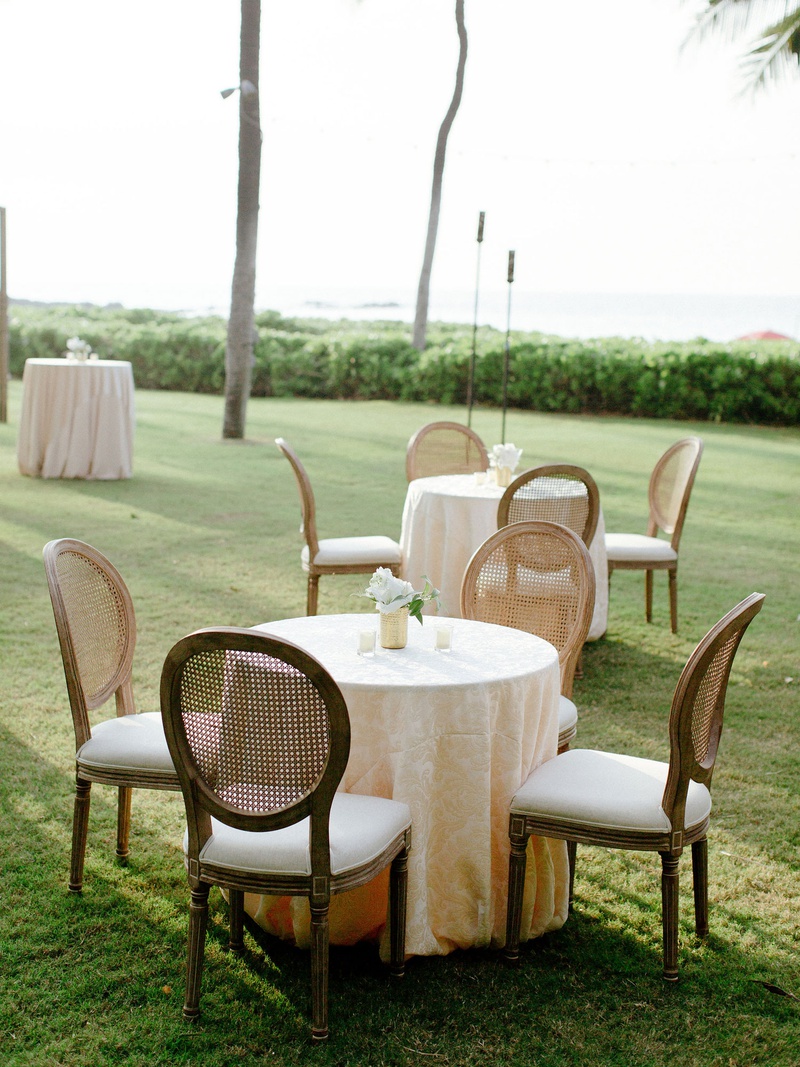 Petite Florals on Cocktail Tables
Photography: Chris J. Evans Photography
Read More:
http://www.insideweddings.com/weddings/outdoor-winter-ceremony-and-reception-on-the-big-island-in-hawaii/1306/ outdoor wedding cocktail hour on grass lawn destination wedding hawaii wood cane back oval chairs