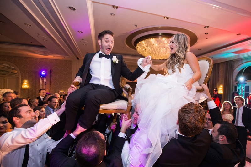 Newlyweds Held Aloft During the Horah
Photography: Duke Photography
Read More:
http://www.insideweddings.com/weddings/jewish-ceremony-classic-ballroom-reception-in-beverly-hills/922/ groom in lanvin, bride in reem acra during the horah at jewish wedding
