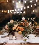 Rustic Fall Small Centerpiece
Photography: Cacá Santoro for Max %26 Friends
Read More:
http://www.insideweddings.com/weddings/intimate-outdoor-ceremony-alfresco-dinner-party-style-reception/1367/ outdoor wedding reception bistro lights small centerpiece kumquats fresh fruit orange dahlia greens