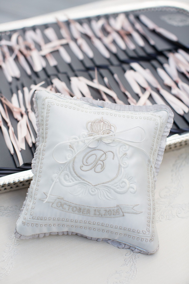 Monogrammed Grey Ring Pillow
Photography: Sarah Kate, Photographer
Read More:
http://www.insideweddings.com/weddings/outdoor-fall-ceremony-opulent-tented-reception-in-dallas-texas/1022/ Wedding rings attached to ring pillow with ribbon grey silver satin monogram and wedding date