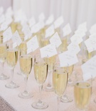 Escort Cards Attached to Champagne
Photography: Kate Osborne Photography
Read More:
http://www.insideweddings.com/weddings/stylish-destination-wedding-with-gorgeous-blooms-in-sundance-utah/1008/ Escort cards place settings on champagne flutes filled with bubbly