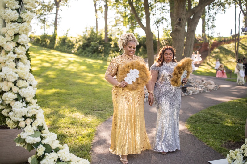 Family Carrying Feathered Fans
Photography: Brian Bossany Photography
Read More:
http://www.insideweddings.com/weddings/luxurious-heaven-inspired-royal-wedding-celebration-in-minneapolis/1333/ mother of bride and mother of groom in gold and silver sequin gowns feather fans outdoor ceremony