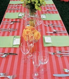 Striped Table Linens
Photography: Barber Photography
Read More:
http://www.insideweddings.com/weddings/tropical-backyard-wedding-with-bright-citrus-hues-in-san-diego/121/ Long table with red stripe tablecloth and green napkins