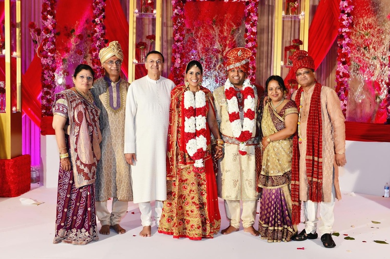 Bride and Groom With Family
Photography: Tomas Ramos Photographers
Read More:
http://www.insideweddings.com/weddings/houston-indian-wedding-celebration-with-800-person-guest-list/435/ Bride in a red lehenga with gold embroidery with groom in gold sherwani with red embroidery