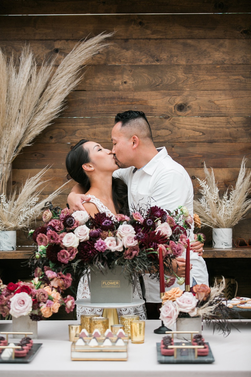 Delivery by Groom
Photography: Jessica Claire Photography
Read More:
http://www.insideweddings.com/weddings/unique-chic-bridal-shower-with-dark-and-moody-color-scheme/1335/ bride and groom kissing at bridal shower after groom delivers flowers