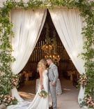 Bride Changes for Rustic Reception
Photography: Christine Bentley Photography
Read More:
http://www.insideweddings.com/weddings/a-rustic-elegant-barn-wedding-in-santa-barbara-california/980/ Bride in Ines Di Santo silky wedding dress groom in grey suit hair down curls drapery barn greenery