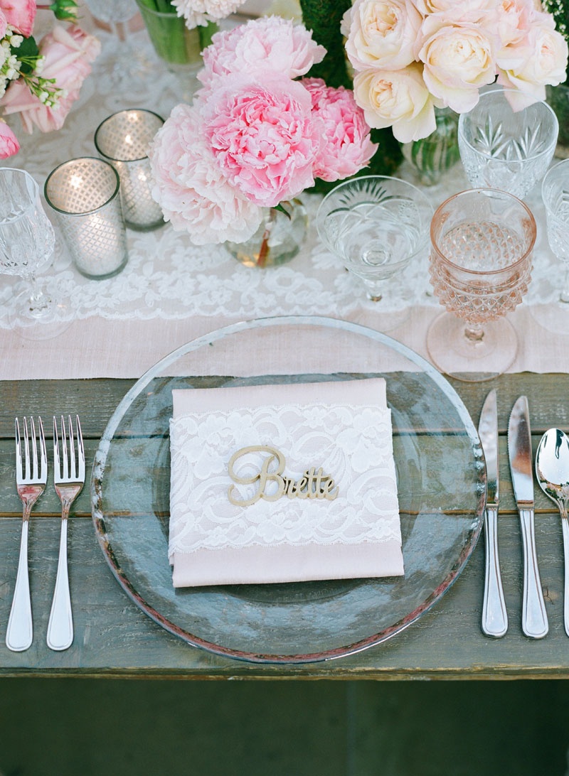 Feminine, Rustic Reception Tablescape
Photography: Elizabeth Messina
Read More:
http://www.insideweddings.com/weddings/fairy-tale-wedding-with-enchanted-forest-theme-in-santa-barbara/778/ Wedding table with wood farm table, laser cut name, pink peony, ivory rose, vintage lace runner