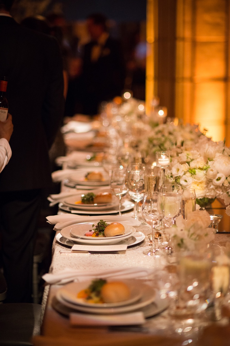 Long Reception Table with Food
Photography: Ira Lippke Studios
Read More:
http://www.insideweddings.com/weddings/chic-classic-new-york-city-wedding-with-personal-touches/783/ a long reception table with white china and low white floral arrangements with food