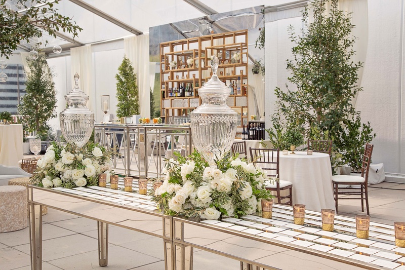 Mirror Escort Card Table Under Tent
Photography: Carasco Photography
Read More:
http://www.insideweddings.com/weddings/traditional-ceremony-glamorous-garden-inspired-tented-reception/943/ Mirror table with white and green flower arrangements escort cards candles cocktail hour