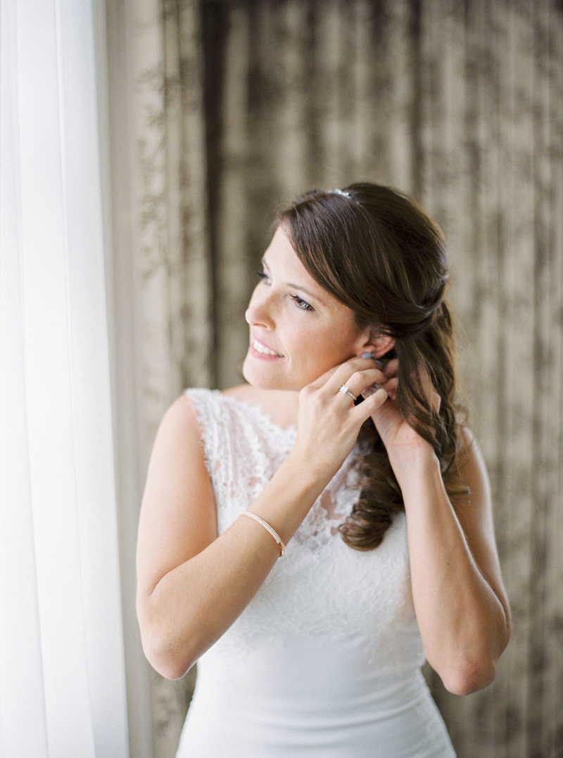 Bride in Bracelet Putting on Earrings
Photography: Branco Prata
Read More:
http://www.insideweddings.com/weddings/chic-destination-wedding-with-california-style-in-washington-dc/1042/ Bride in bridal suite hair pulled back soft curls The White Dress bridal gown ring bracelet headband