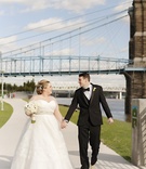 Couple Holds Hands by Bridge
Photography: Kortnee Kate Photography
Read More:
http://www.insideweddings.com/weddings/glitzy-glamorous-wedding-with-black-gold-palette-in-cincinnati/1056/ bride in strapless sweetheart watters wedding dress, groom in michael kors tux, bridge