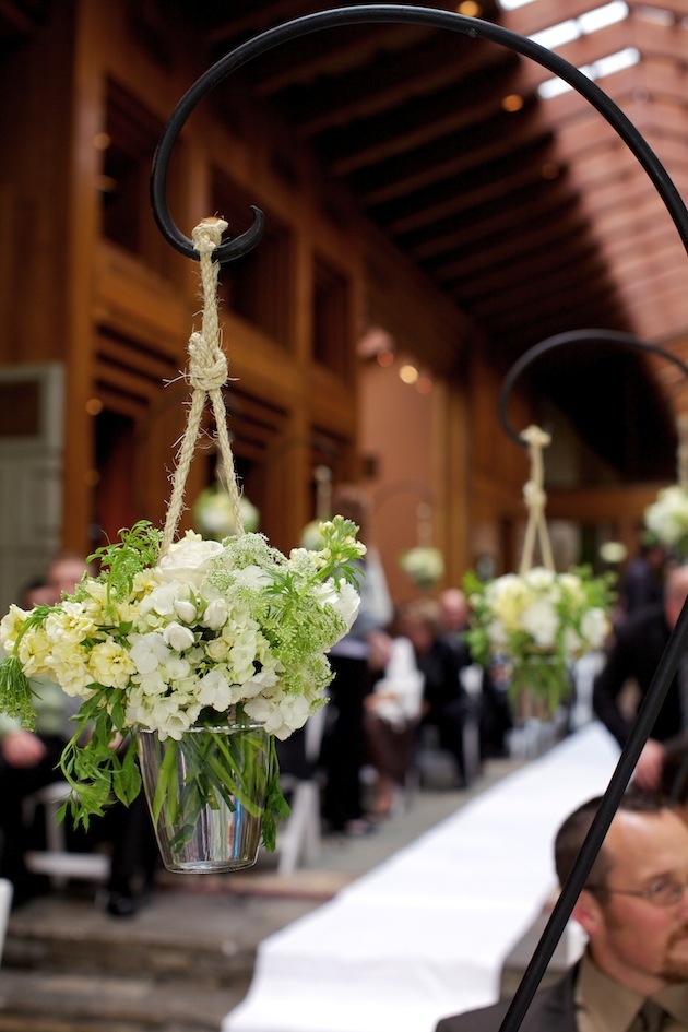 Rustic Aisle Decorations
Photography: D. Park Photography
Read More:
http://www.insideweddings.com/weddings/rustic-spring-wedding-in-southern-california/454/ Shepherd hook holding white flowers hanging from rope